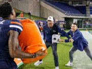 L’allenatore dell’UTSA cerca esilarante di sfuggire alla doccia celebrativa e finisce in una catasta di cani